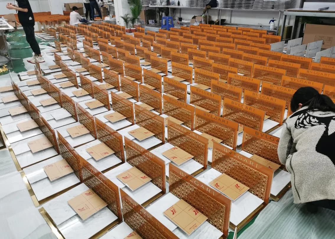 Rows of fabricated Bulgari counter display pieces laid out on the floor
