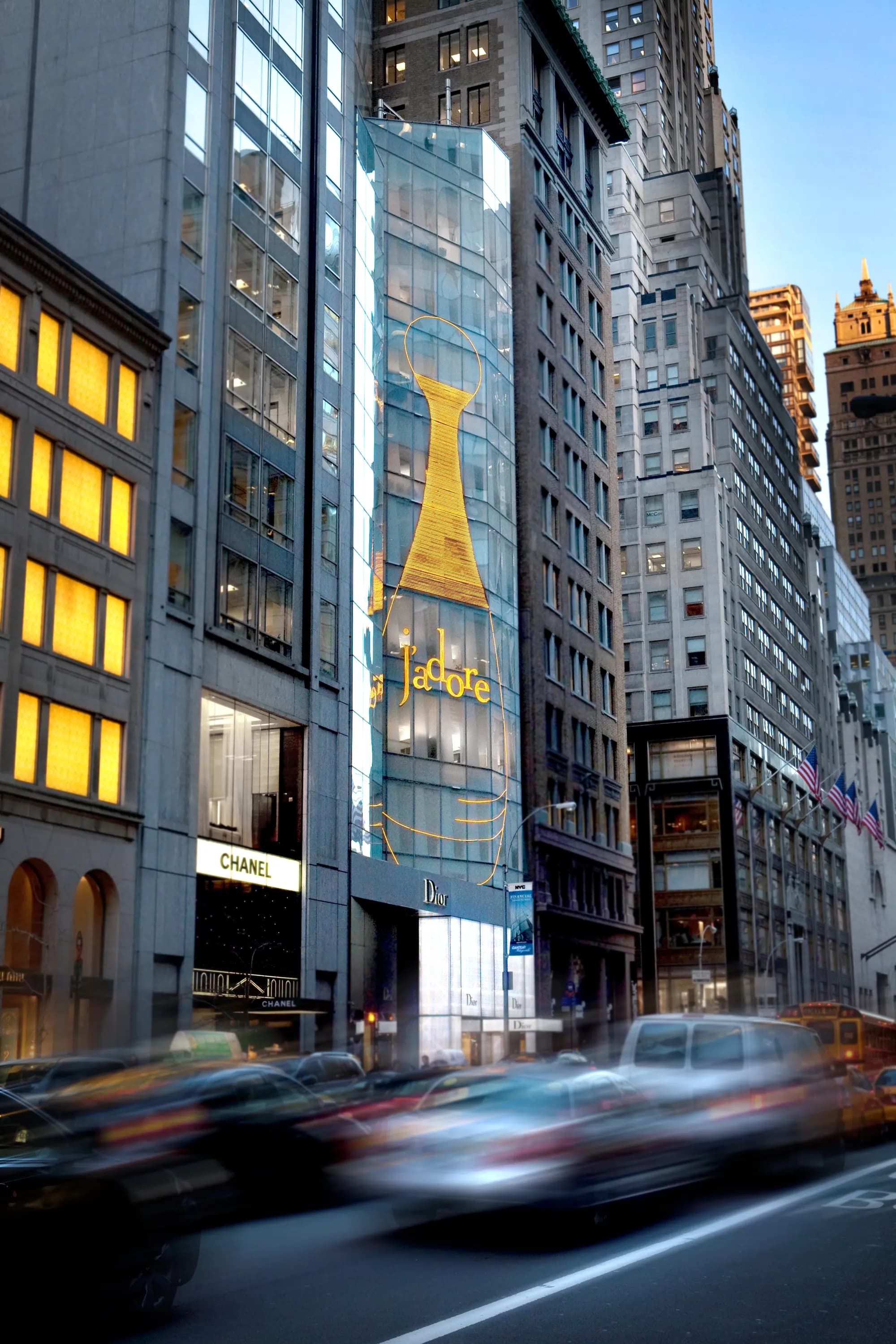 Street-level view of the Dior 57th Street flagship and J'adore facade with traffic light trails