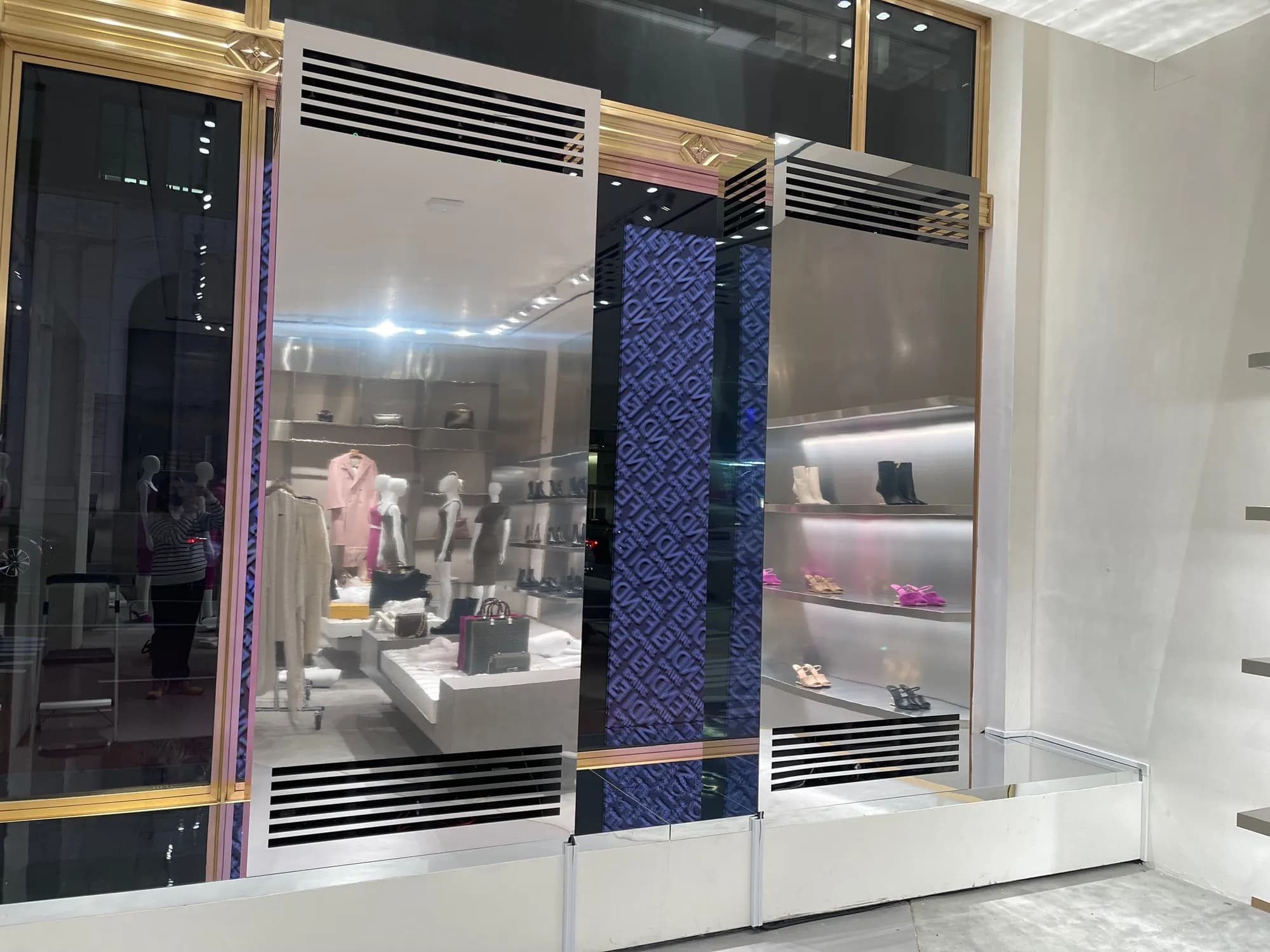 Mirrored steel housings built around the Fendi x Skims LED screens in the 57th Street windows