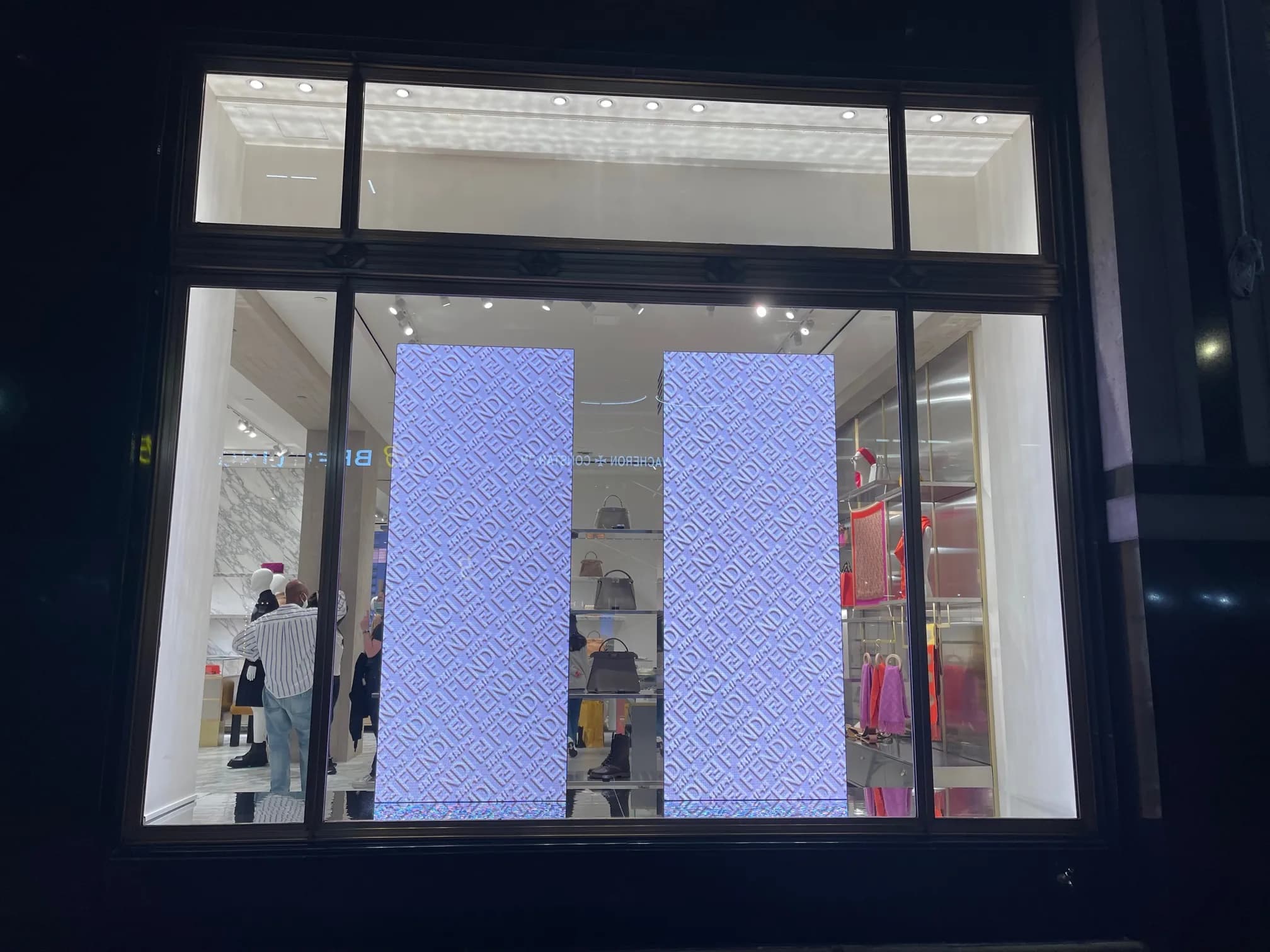 Fendi x Skims window on 57th Street at night, two LED columns glowing in the FF pattern