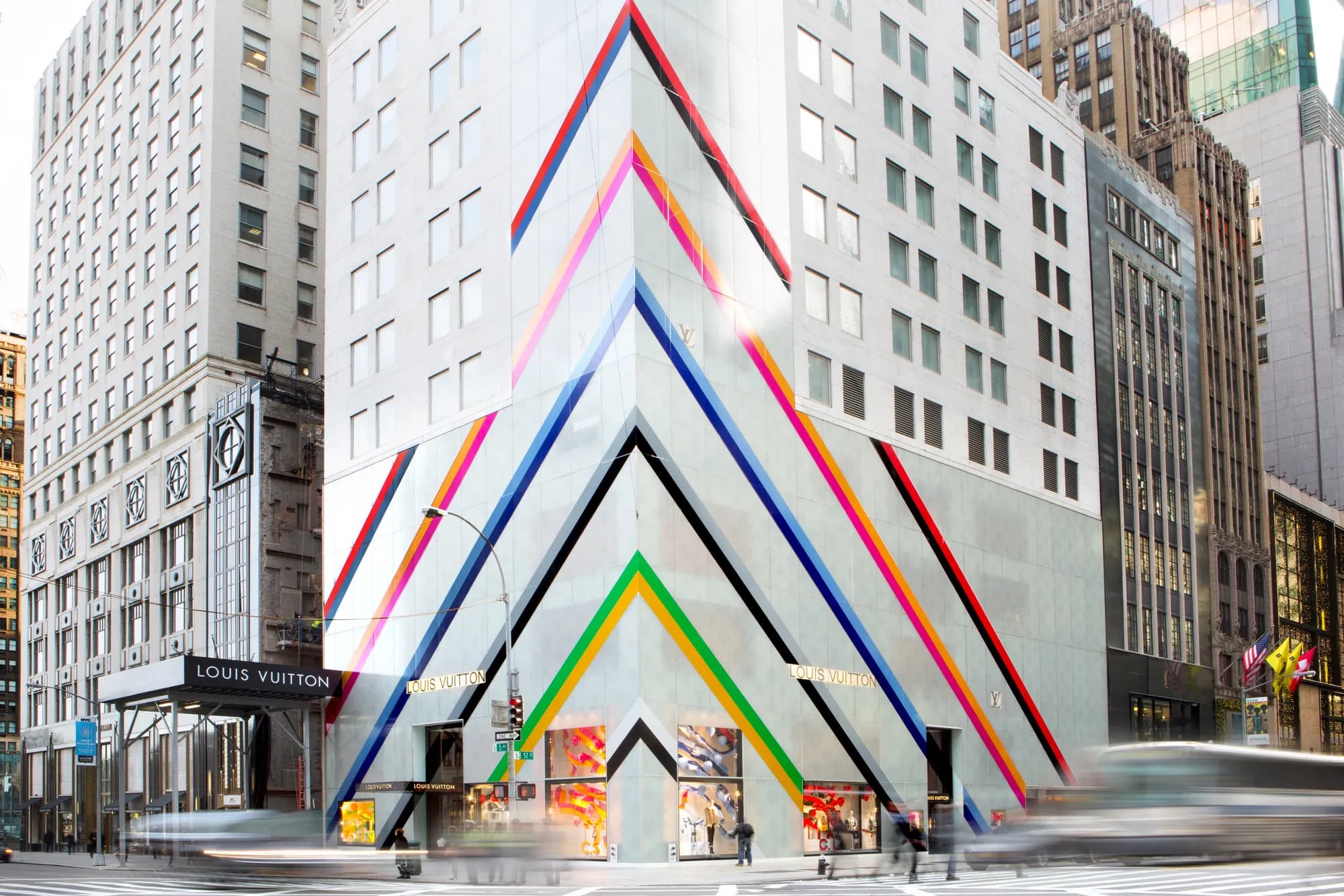 Louis Vuitton building wrapped in rainbow chevron stripes rising from the storefront