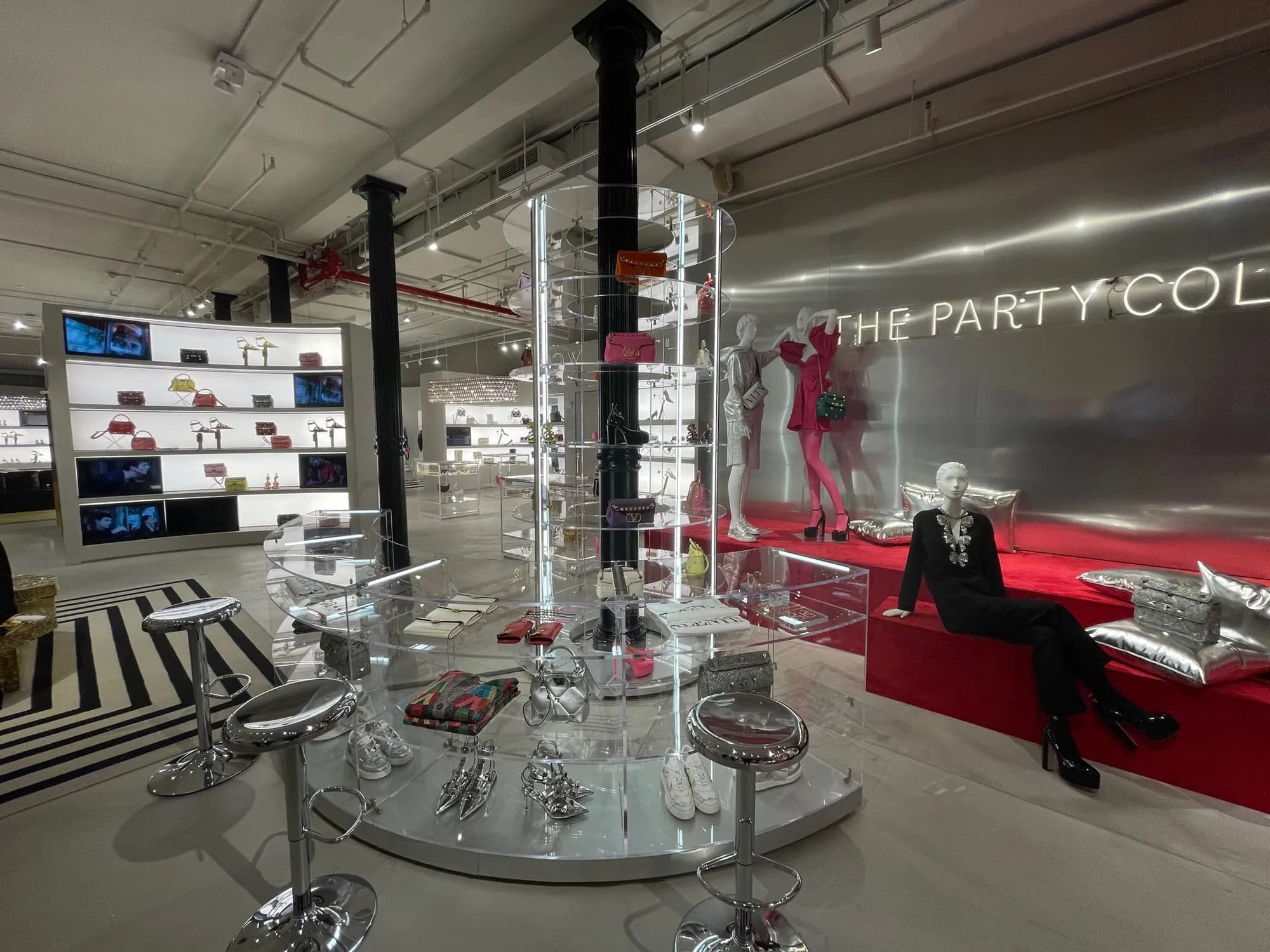 Valentino Soho takeover with checkerboard floor, silver walls and illuminated shelving