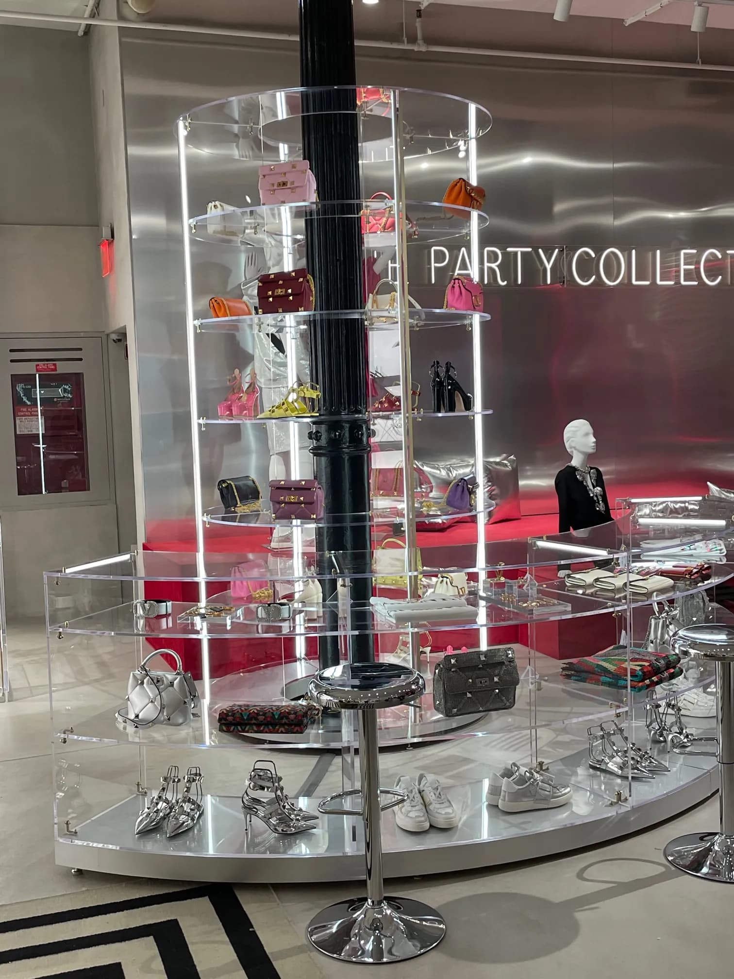 Tall acrylic display column filled with Valentino accessories, Soho