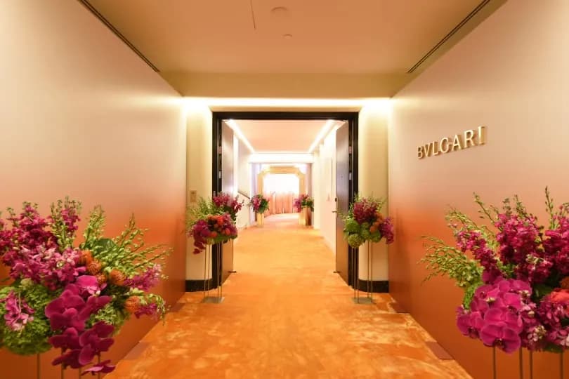 Bulgari private shopping event in a penthouse, a flower-lined corridor leading into the salon